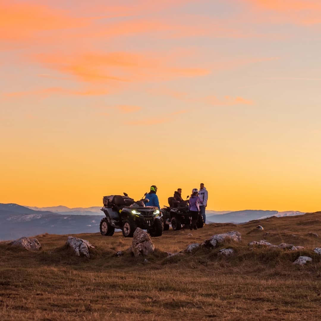 Group four wheeling at sunset
