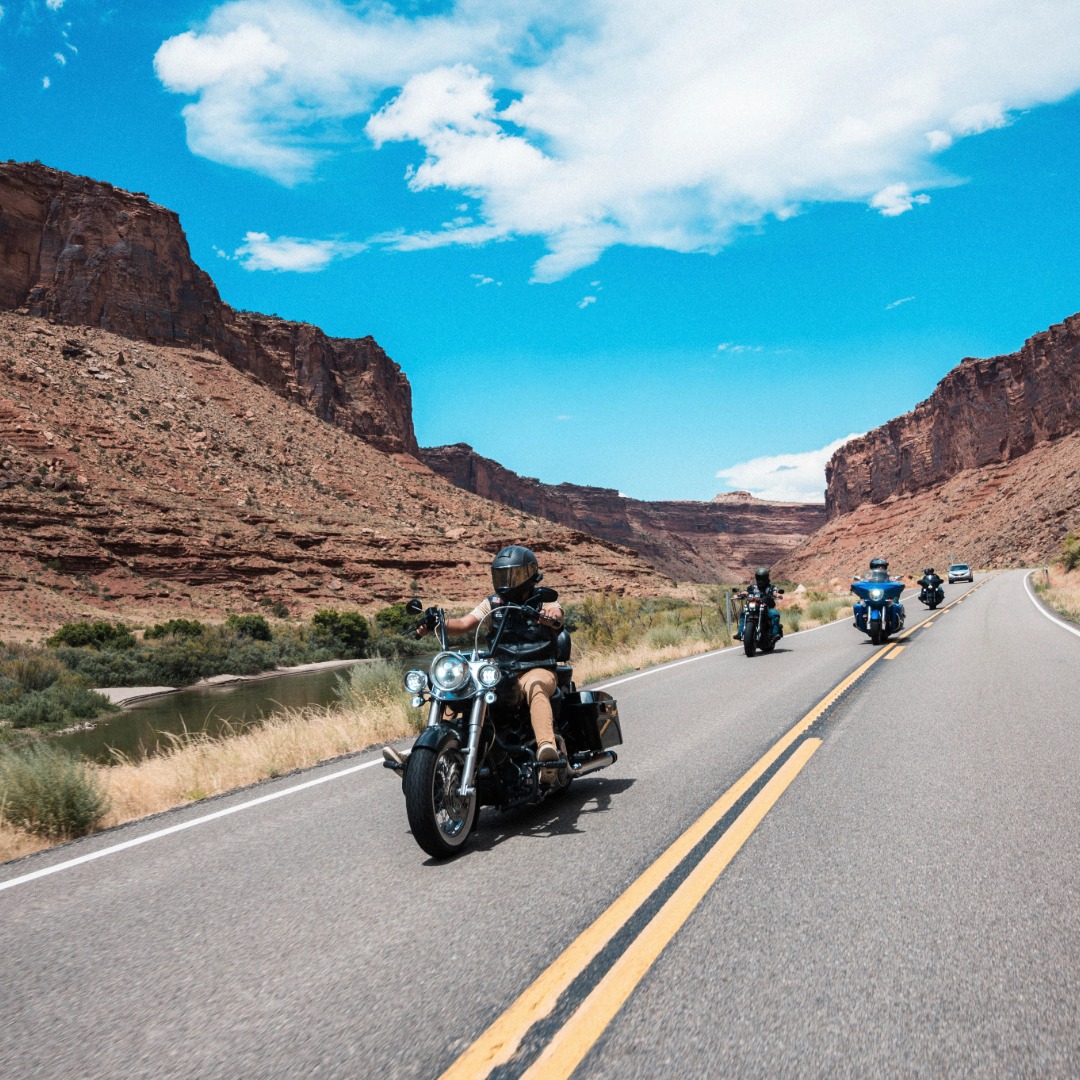 Motorcycle riders going down the road